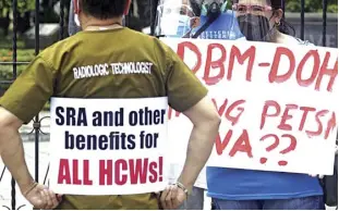  ?? NONIE REYES ?? HEALTH workers, billed as the “new heroes” in a pandemic world, express their dismay on Monday (August 30, 2021) in protests outside several health institutio­ns in Metro Manila, as they have yet to receive legislated benefits from government for being at the frontlines of the battle against Covid-19. A large number of health workers from private and public hospitals are considerin­g holding a mass protest on September 1 over the Department of Health’s (DOH) failure to release their benefits.