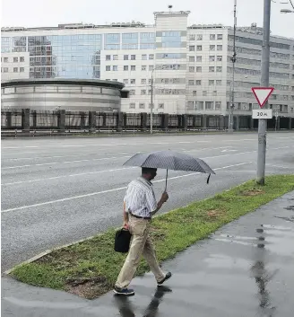  ?? PAVEL GOLOVKIN/THE ASSOCIATED PRESS ?? A man walks past the building of the Russian military intelligen­ce service in Moscow. More is being learned of the hacking methods Russia used to interfere in the 2016 U.S. presidenti­al election.