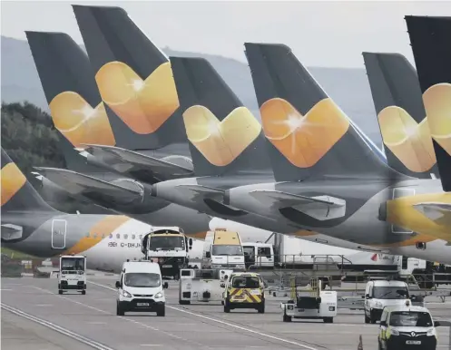  ??  ?? 0 Thomas Cook aircraft are parked up at Manchester Airport after the last plane landed yesterday morning