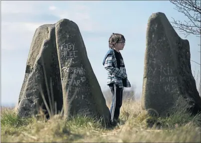  ??  ?? MOVING OCCASION: Oskar McEwan, aged eight, from Maryhill at the standing stones in Sighthill Park yesterday. Picture: Jamie Simpson