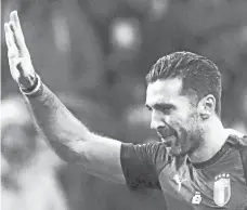 ?? AP Photo/Luca Bruno ?? FAREWELL. Italy's goalkeeper Gianluigi Buffon waves as he leaves the pitch after the eliminatio­n of his team in the World Cup qualifying play-off second leg soccer match between Italy and Sweden, at the Milan San Siro stadium, Italy, Monday, Nov. 13,...