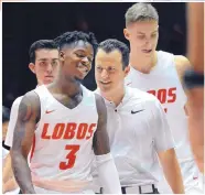  ??  ?? LEFT: Lobos coach Paul Weir, center, talks with Antino Jackson during a break in the action against the Cougars. A crowd of almost 5,000 got to see UNM in game action for the first time this season.