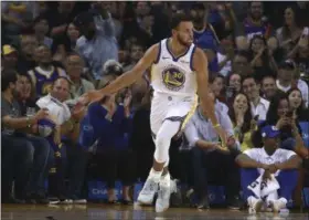  ?? BEN MARGOT - THE ASSOCIATED PRESS ?? Golden State Warriors’ Stephen Curry celebrates after scoring against the Phoenix Suns during the first half of a preseason NBA basketball game Monday, Oct. 8, 2018, in Oakland, Calif.