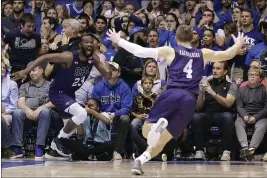  ?? PHOTOS BY GERRY BROOME — THE ASSOCIATED PRESS ?? Stephen F. Austin forward Nathan Bain (23) and guard David Kachelries (4) celebrate Bain’s game-winning basket against Duke in overtime on Tuesday in Durham, N.C.