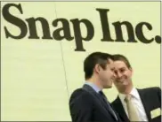  ?? THE ASSOCIATED PRESS ?? Snapchat co-founders Bobby Murphy, left, and CEO Evan Spiegel ring the opening bell at the New York Stock Exchange as the company celebrates its IPO on Thursday.