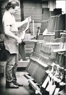  ??  ?? A Marlin employee inspects a gun in a shipping room in October 1990.