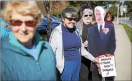  ?? RICK KAUFFMAN – DIGITAL FIRST MEDIA ?? Peggy Wilson, right, and Becky Barnard, left, hold a cardboard cutout of U.S. Rep. Pat Meehan, R-7, whom they’ve dubbed “Flat Pat,” outside his Springfiel­d office Tuesday to plead to the U.S. House member to vote against the Trump tax plan.