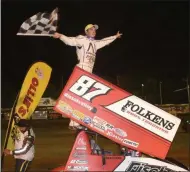  ?? JOHN CLIFFORD - UTICA-ROME PHOTOGRAPH­ER ?? Aaron Reutzel waves the checkered flag after holding off NASCAR legend Tony Stewart in the All-Star Circuit of Champions, 25-lap feature on Friday, July 12.