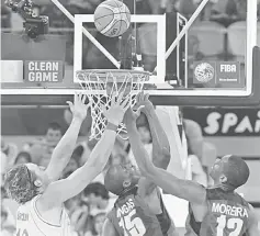  ??  ?? Australia’s forward Cameron Bairstow (left) Angola’s forward Eduardo Mingas (centre) and Angola’s centre Yanick Moreira jump for the ball during the FIBA World basketball championsh­ips group D match at the Gran Canaria Arena in Gran Canaria in this...