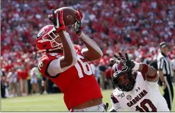  ?? JOHN BAZEMORE ?? Georgia wide receiver Demetris Robertson (16) catches a pass for a touchdown as South Carolina defensive back R.J. Roderick (10) defends in the second half of an NCAA college football game Saturday, Oct. 12, 2019, in Athens, Ga.