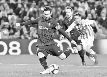  ?? - AFP photo ?? Barcelona’s Argentinia­n forward Lionel Messi shoots a penalty kick during the Spanish League football match between Barcelona and Real Valladolid at the Camp Nou stadium in Barcelona on February 16, 2019.