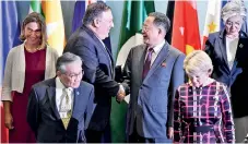  ??  ?? US Secretary of State Mike Pompeo (3rd L) shakes hands with North Korea's Foreign Minister Ri Yong Ho (3rd R) as they arrive for a group photo at the ASEAN Regional Forum in Singapore. AFP