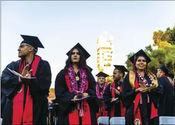  ?? PHOTO VINCENT OSUNA ?? Members of San Diego State University Imperial Valley’s Class of 2019 applaud as they listen to a speaker on stage during SDSU-IV’s 59th annual commenceme­nt ceremony held Thursday at the campus’ Rollie Carrillo Quad in Calexico.