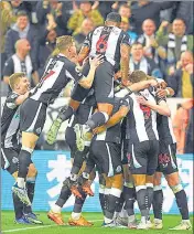  ?? AFP ?? Newcastle players celebrate after scoring against Arsenal at St James' Park on Monday.