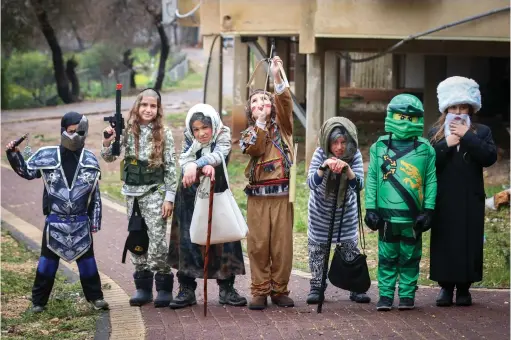  ?? (David Cohen/Flash90) ?? CHILDREN IN Safed dress up for Purim last week. The author writes about spending the holiday in Amman with a group of tourists.