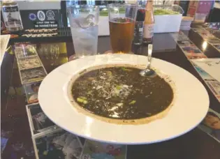  ?? PHOTO BY JIM TANNER ?? A bowl of chicken, duck and andouille gumbo with rice is $13 at Parkway Pourhouse.