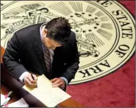  ?? Arkansas Democrat-Gazette/JEFF MITCHELL ?? Senate President Pro Tempore Jonathan Dismang, R-Searcy, takes notes on the agenda during the state Senate’s session Monday. The House didn’t meet.