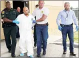  ??  ?? Quadruple murder suspect Bryan Riley is led from the Polk County Sheriff’s Office in Lakeland, Fla., on Sunday, Sept 5, 2021, by Deputy Steve Neil (left), Captain Bart Davis and Detective Brett Bulman. (AP)