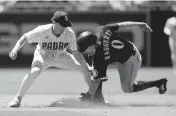  ?? GREGORY BULL AP ?? Seattle’s Sam Haggerty beats the tag of Jake Cronenwort­h to steal second base Tuesday.