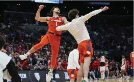  ?? AP ?? Clemson guard Chase Hunter (left) and forward Daniel Nauseef celebrate after a win over Arizona in a Sweet 16 game in the NCAA tournament Thursday in Los Angeles. Hunter scored 18 points and converted a three-point play with 25.7 seconds left.