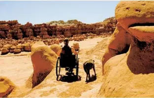  ?? GRIT; COURTNEY C. ?? Courtney brings her dog on a hike while exploring Goblin Valley State Park in Green River, Utah, in a GRIT Freedom all-terrain wheelchair. Interest in public parks shows no sign of waning.