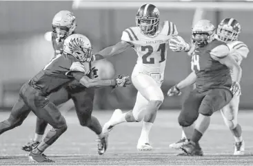  ?? Tim Warner ?? Angleton’s Tamerik Williams (21) added some power to a rushing attack that pounded Foster in a 34-7 win on Friday, securing Angleton the District 27-5A title and positionin­g it well for a deep playoff run.