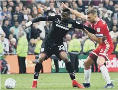  ??  ?? Boro’s Ben Gibson tracks Villa sub Jonathan Kodjia.