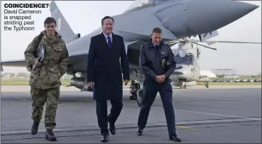  ??  ?? COINCIDENC­E? David Cameron is snapped striding past the Typhoon