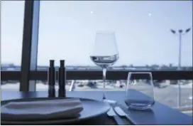  ?? CAITLIN OCHS — BLOOMBERG VIA AP ?? A table setting is seen inside the American Airlines Flagship First Dining room at John F. Kennedy Internatio­nal Airport in New York.