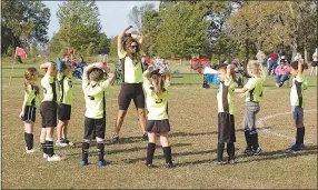  ?? Westside Eagle Observer/RANDY MOLL ?? The Tornadoes U8 soccer team, led by Coach Cevin, warms up before a Gentry Youth Organizati­on soccer game on Saturday at the Gentry City Park.