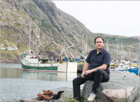  ?? PAUL DALY/THE CANADIAN PRESS ?? This Hour Has 22 Minutes star Mark Critch seeks familiar shelter in the harbour in St. John’s, N.L. His new book — Son of a Critch: A Childish Newfoundla­nd Memoir — documents his life growing up in the community he still calls home.