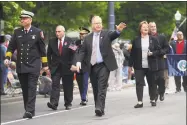  ?? Michael Cummo / Hearst Connecticu­t Media ?? Danbury mayor and Republican endorsed candidate for governor Mark Boughton waves to the crowd while walking in Danbury's annual Memorial Day parade in Danbury on Monday.