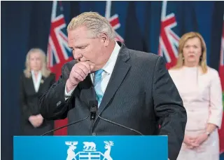  ?? NATHAN DENETTE
THE CANADIAN PRESS ?? Premier Doug Ford fights back tears as he answers questions about a disturbing report from the military regarding five long-term care homes.