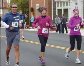  ??  ?? Francis, pictured middle, runs at the Minster Oktoberfes­t 10K at age 72 with her pearls and two of her children, Lance Franics (left) from Ft. Lauderdale, FL and Tisha Huth (right) of Sidney.
