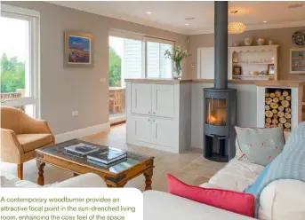  ??  ?? A contempora­ry woodburner provides an attractive focal point in the sun-drenched living room, enhancing the cosy feel of the space