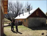  ?? GIOVANNA DELL’ORTO / AP ?? ‘Hermanos’ Fidel Trujillo, left, and Leo Paul Pacheco, look at the kitchen recently built with adobe next to the 1860s ‘morada’ de San Isidro, which is the main chapel and meeting point of their Catholic brotherhoo­d, outside Holman, N.M., on April 15.