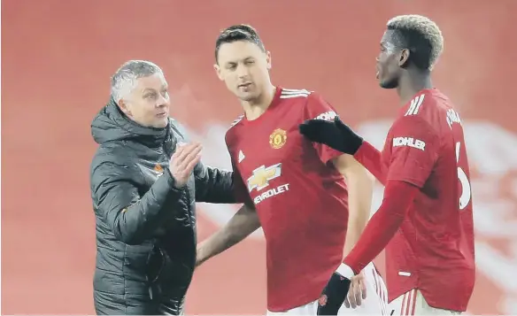  ??  ?? Manchester United manager Ole Gunnar Solskjaer congratula­tes Nemanja Matic and Paul Pogba.