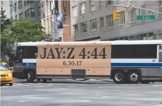  ??  ?? A NEW YORK City bus with an advertisem­ent for Jay-Z’s new album 4:44 turns a corner in midtown New York City on June 26.