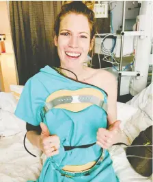  ??  ?? Calgary photograph­er Leya Russell shows off her new custom back brace and takes some of her first steps in a Bangkok, Thailand hospital since fracturing two vertebrae in a plane crash in Myanmar on May 8.