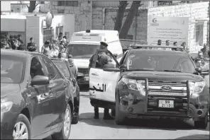  ?? AP/RAAD ADAYLEH ?? An ambulance transports the body of Jordanian writer Nahed Hattar to a hospital after he was shot in Amman, Jordan, on Sunday.