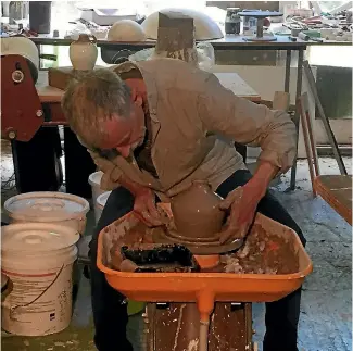  ??  ?? West Coast potter Chris Lewis making one of 100 limited-edition ceramic jugs for the first batch of Reefton Distilling Co’s The Real Mackay whisky, which will be distilled this year.