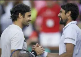  ?? THE ASSOCIATED PRESS ?? Roger Federer, of Switzerlan­d, left, shakes hands with Jeremy Chardy, of France, after Federer’s win at the BNP Paribas Open tennis tournament Wednesday in Indian Wells