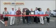 ?? MONICA SAGER — DIGITAL FIRST MEDIA ?? The Boyertown Museum of Historic Vehicles added six electric vehicle charging stations to their parking lot. In this photo, museum officials and guests cut a ribbon to mark the occasion.