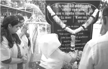  ??  ?? Staff of the Cama Hospital, one of the targets of the 2008 Mumbai militant attacks, pay respects at the memorial during an event to commemorat­e the 10th anniversar­y of the attacks in Mumbai. — AFP photo