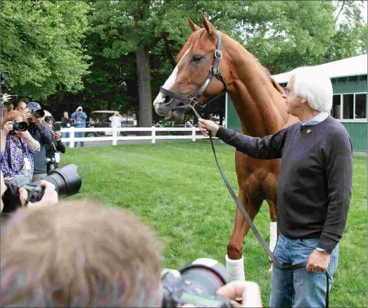  ?? BARBARA D. LIVINGSTON ?? Bob Baffert and Justify pose for photos. Justify figures to be Baffert’s fourth straight 3-year-old champion, following American Pharoah (2015), Arrogate (2016), and West Coast (2017).