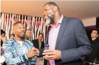  ?? STAFF PHOTOZ BY NICOLAUS CZARNECKI ?? At far left, actor Jamie Foxx strikes a pose with JetLux CEO Tom Osovitzki, center, and W Boston General Manager Gurkirat Singh during a party at the hotel this weekend. Above, Foxx chats with Celtics assistant coach Walter McCarty.