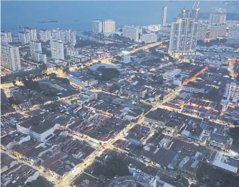  ?? REUTERS PHOTOS BY ?? A general view of Penang, once called the ‘Silicon Valley of the East’ for its massive electrical and electronic­s (E&E) industry before it lost its shine to China.