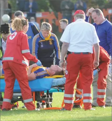  ??  ?? Medical staff tend to St Mochta’s Ciaran Byrne during Sunday’s IFC final at The Grove.