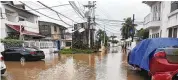  ?? AP ?? Cars are parked on a flooded street in the aftermath of Hurricane Julia in San Andres island, Colombia, Sunday. Julia then hit Nicaragua’s Caribbean coast Sunday.