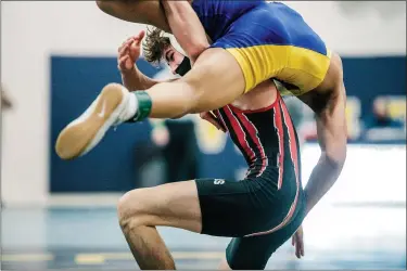  ?? NATE HECKENBERG­ER - FOR MEDIANEWS GROUP ?? Boyertown’s Jay Maldonado lifts Downingtow­n East’s Keanu Manuel en route to winning the 120-pound crown.